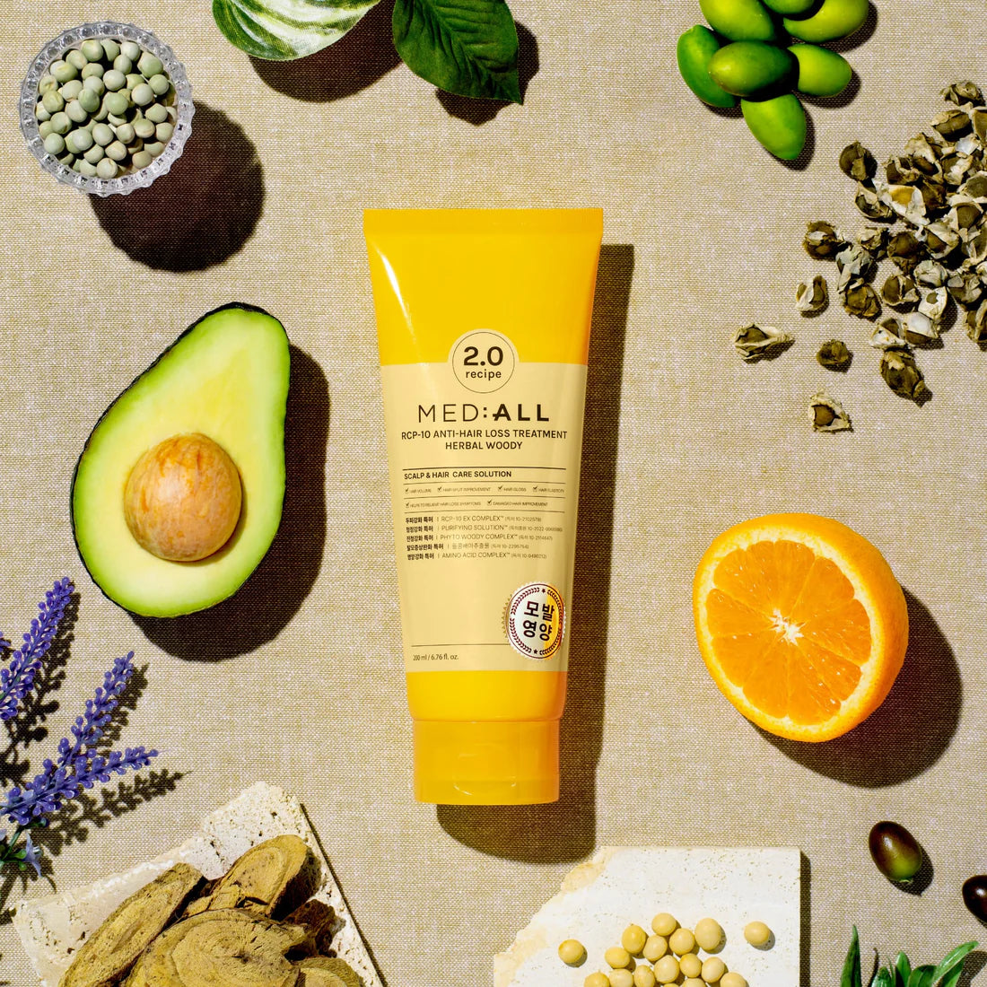 Rcp-10 Anti Hair Loss Treatment Herbal Woody 200ml tube placed upright with its natural herbal ingredients arranged around it