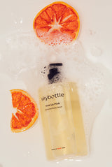 Skybottle Perfumed Body Wash Viva La Vida 300ml bottle with oranges in background