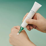 Applying SKIN1004 Tea-Trica Spot Cream on acne spots for targeted blemish care