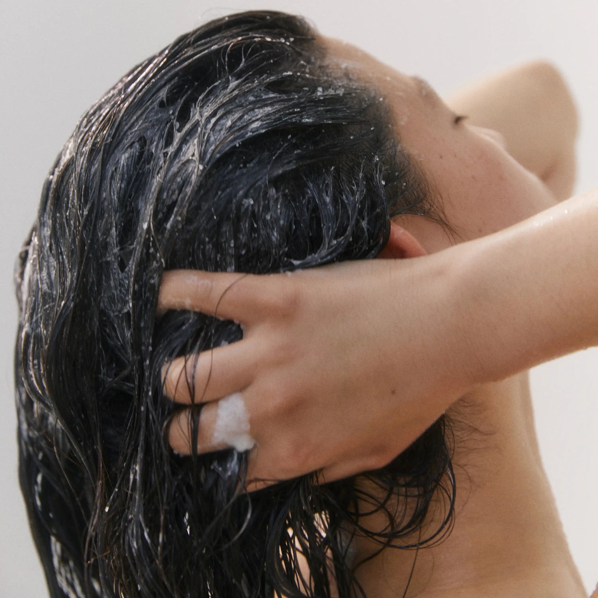 Aromatica Rosemary Salt Scrub Shampoo being used on hair