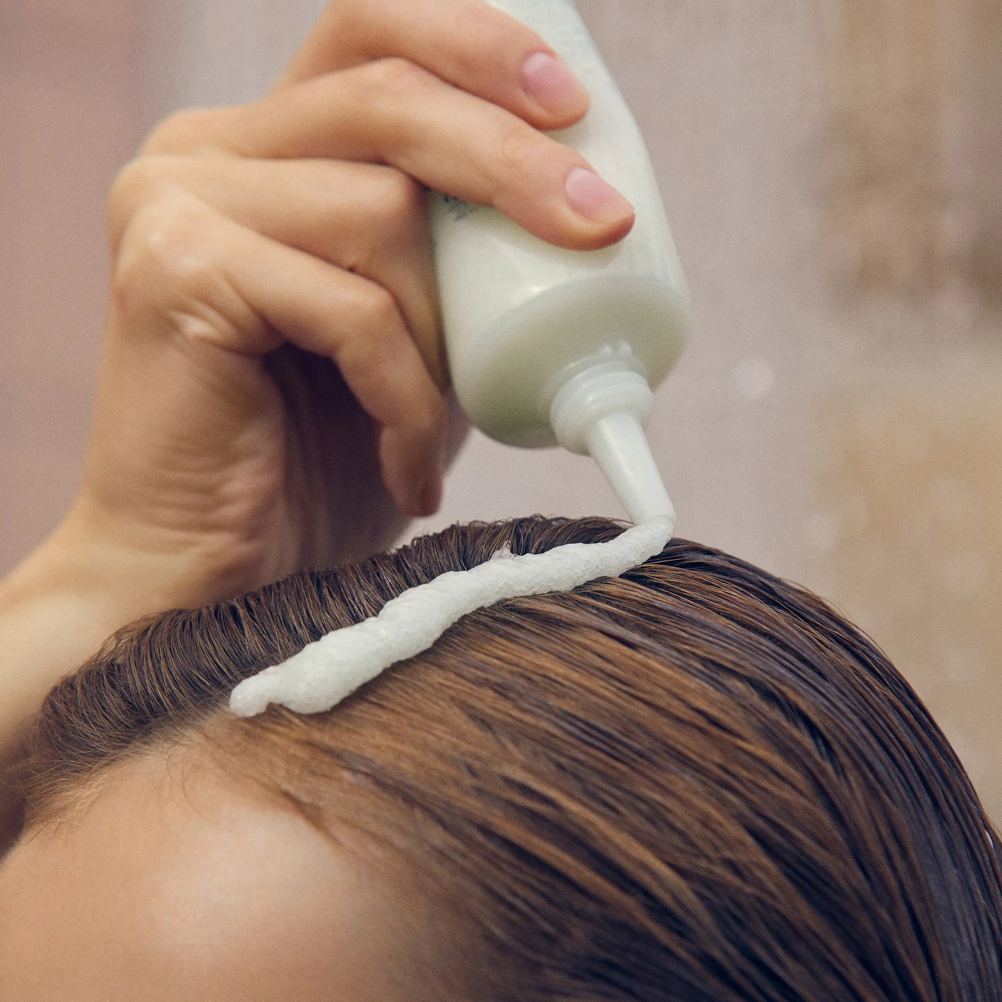 Aromatica Rosemary Scalp Scrub being massaged on scalp