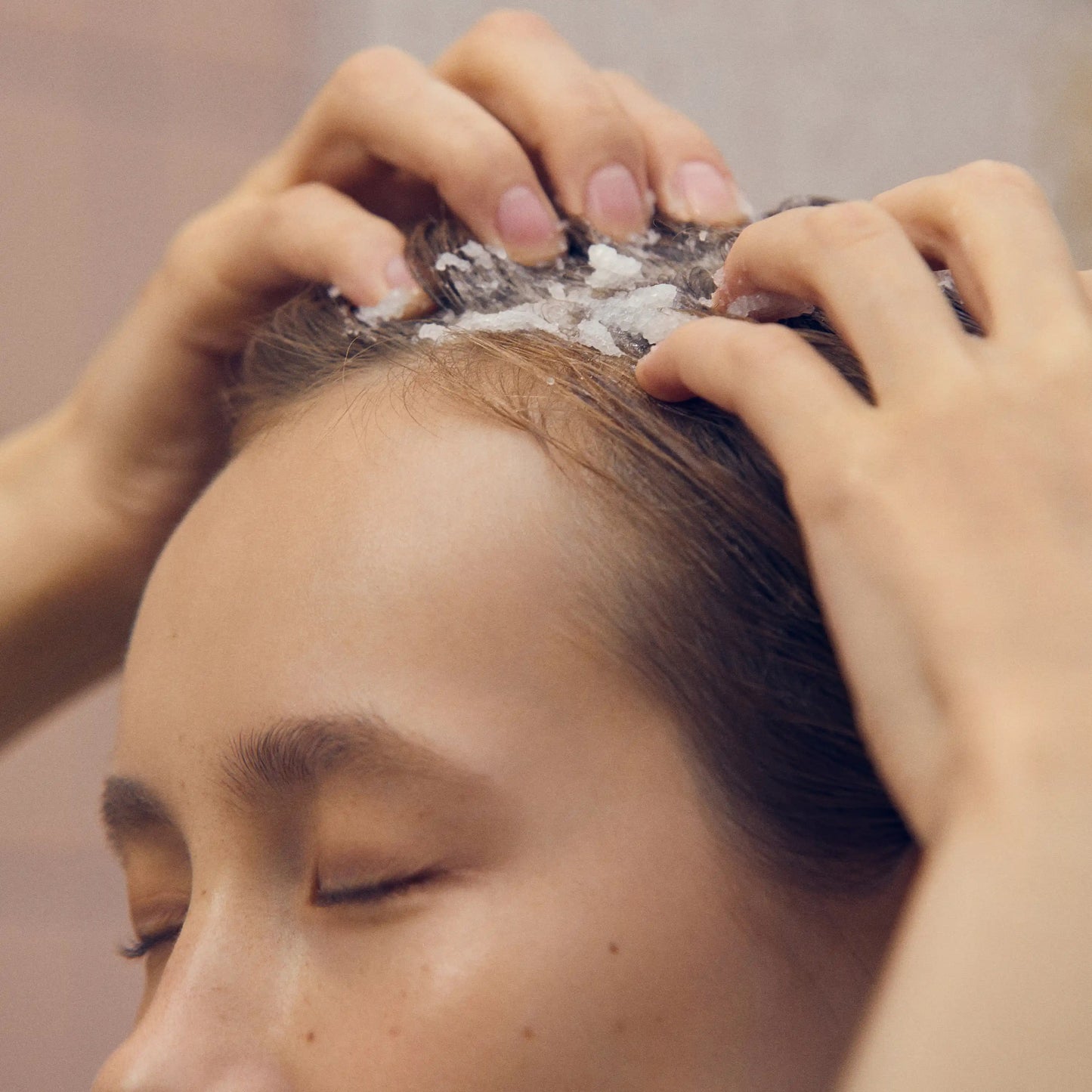 Aromatica Rosemary Scalp Scrub being squeezed onto scalp