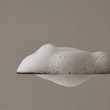 Aromatica Tea Tree Purifying Shampoo foam scooped with spatula