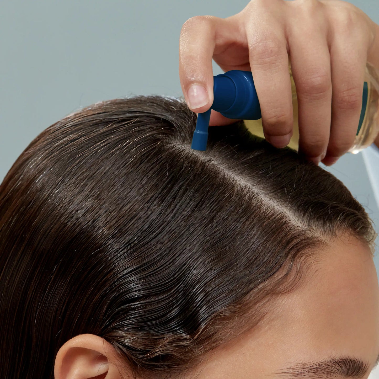 Aromatica Tea Tree Purifying Tonic being sprayed on scalp