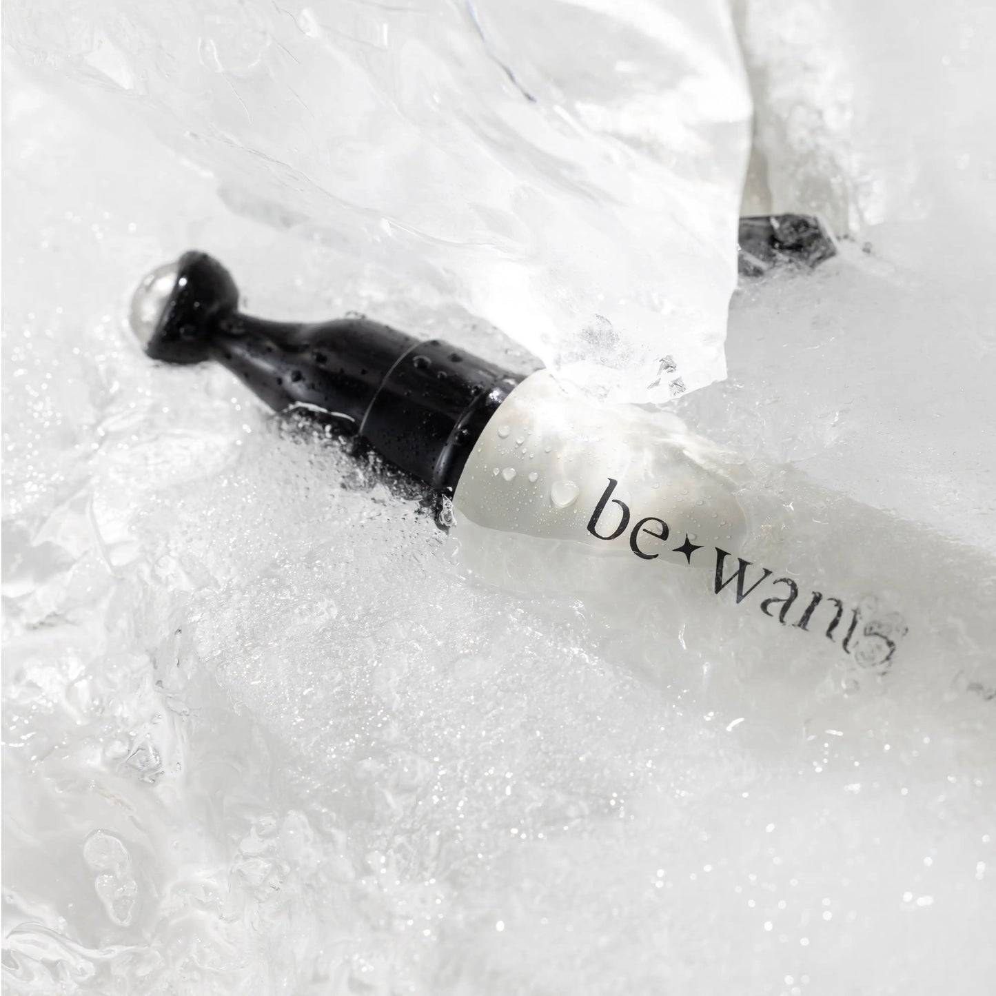 Bewants Phyto Collagen Eye Serum Stick applicator submerged in water close-up