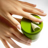 Hand scooping freshly ground Beplain Mung Bean Pore Grinding Cleansing Balm 100ml directly from the twist dispenser container