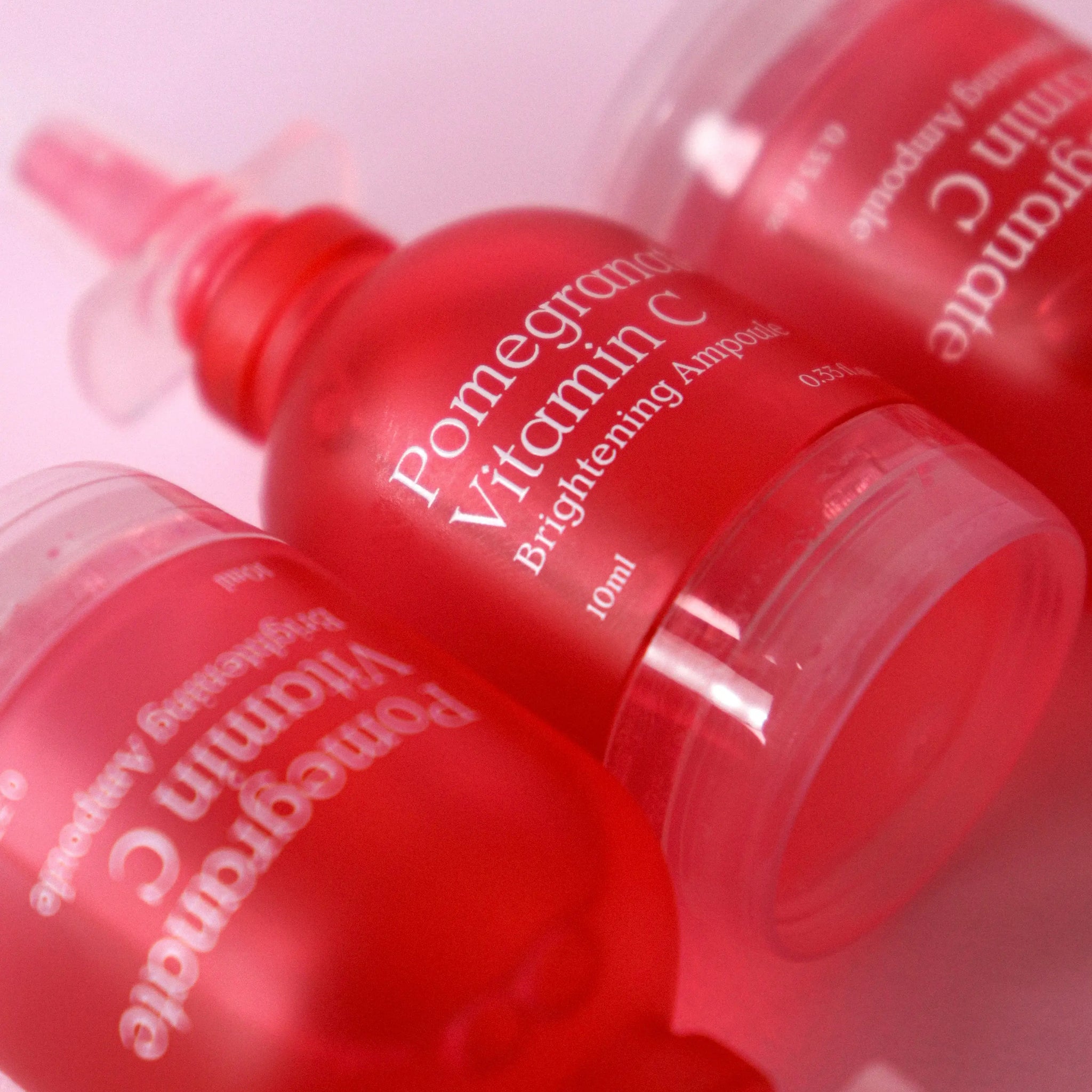 Multiple NDP Pomegranate Vitamin C Brightening Ampoule bottles arranged to showcase product line