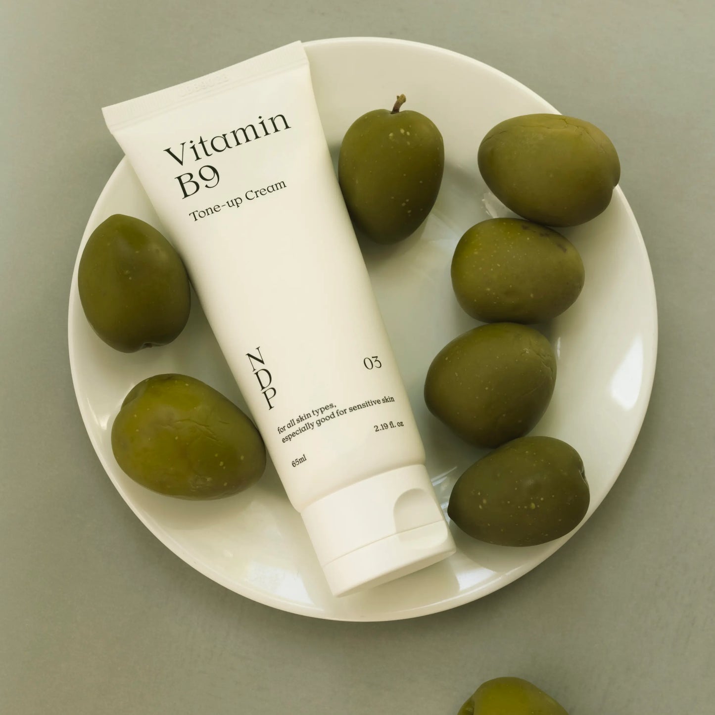 NDP Vitamin B9 Tone-up Cream in a minimal skincare setup for fresh no-makeup makeup look