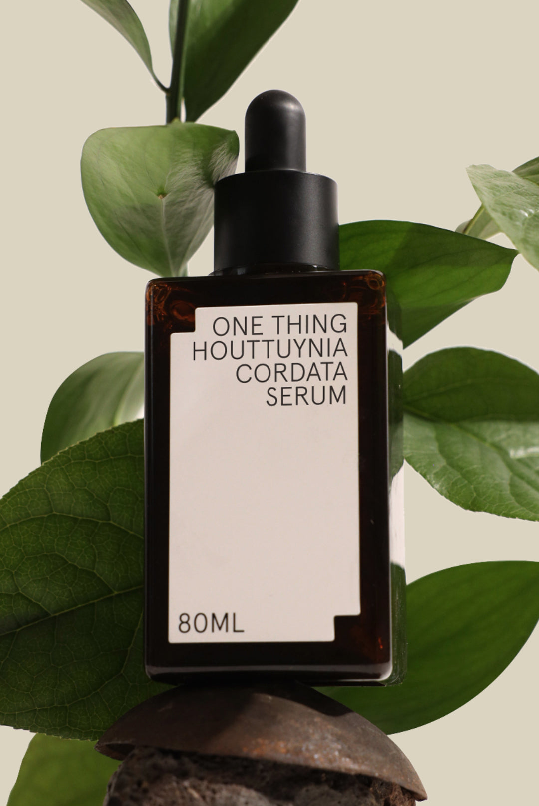 One Thing Houttuynia Serum bottle with leaves