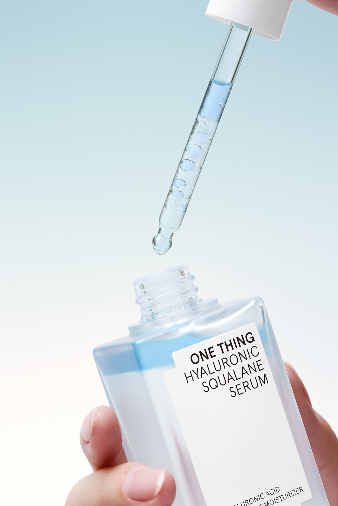 One Thing Hyaluronic Squalane Serum dispensed from dropper