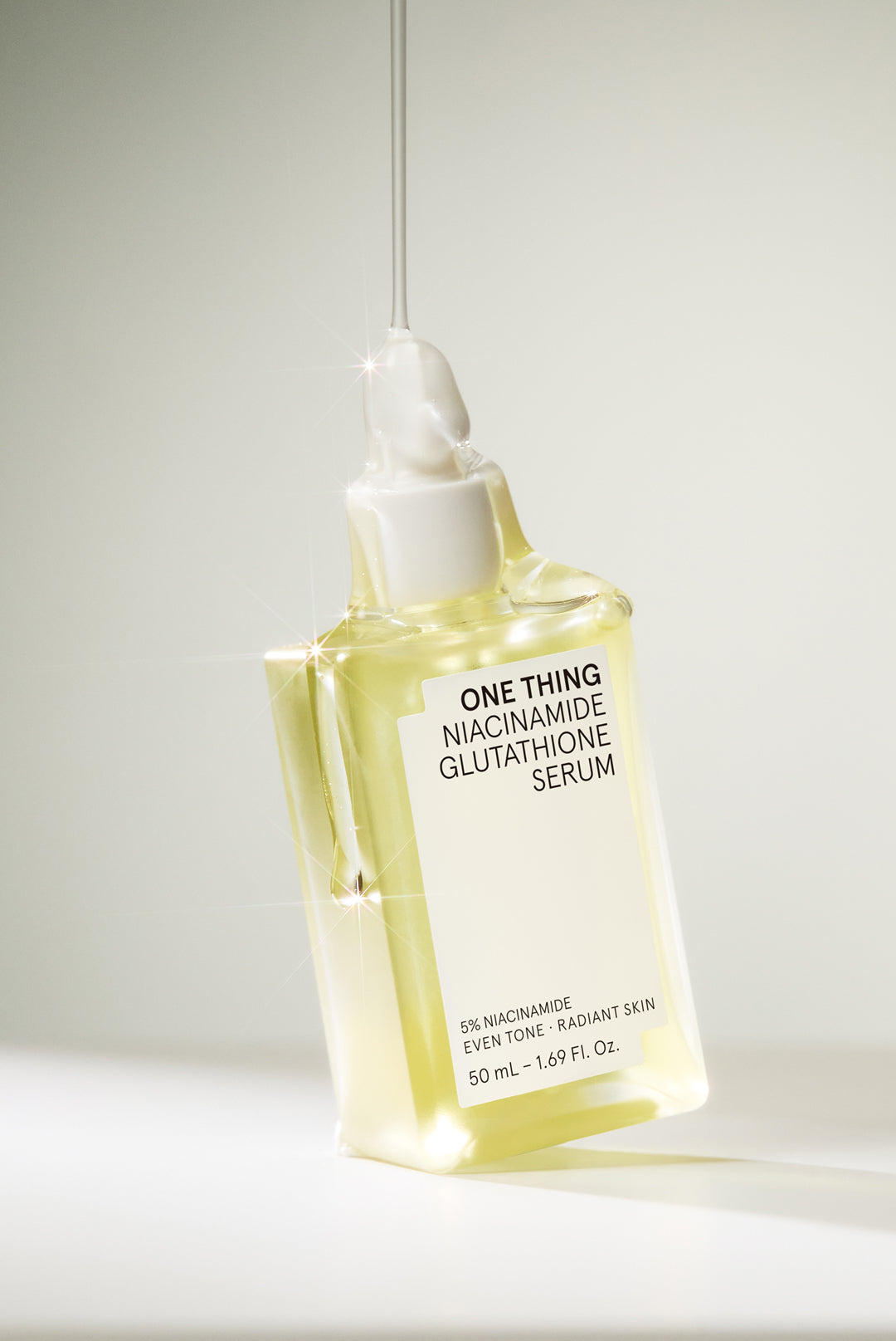 One Thing Niacinamide Glutathione Serum dripping over bottle