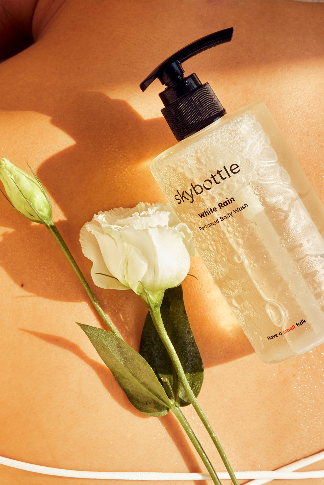 Skybottle Perfumed Body Wash White Rain 300ml bottle with white roses in background