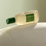 Aromatica Rosemary Scalp Scaling Shampoo product dripping from bottle